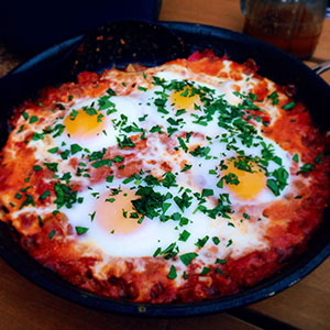 a pan of shakshuka with poached eggs